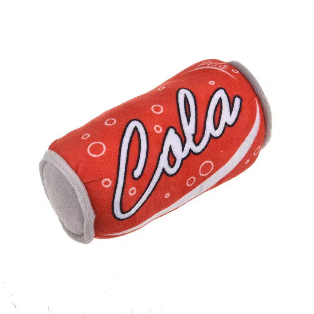 Red cylindrical toy resembling a cola can with 'Cola' text on a white background